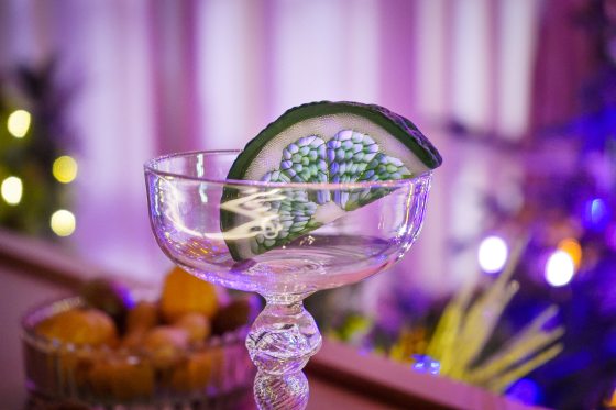 A glass lime wedge resting in an empty margarita glass.